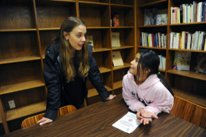 UMW's Rappahannock Scholars program helped put senior Samantha St. John on a path to college. Here, St. John talks with her pen pal, an ESL student in the city’s Lafayette Upper Elementary School. Photo by Suzanne Carr.