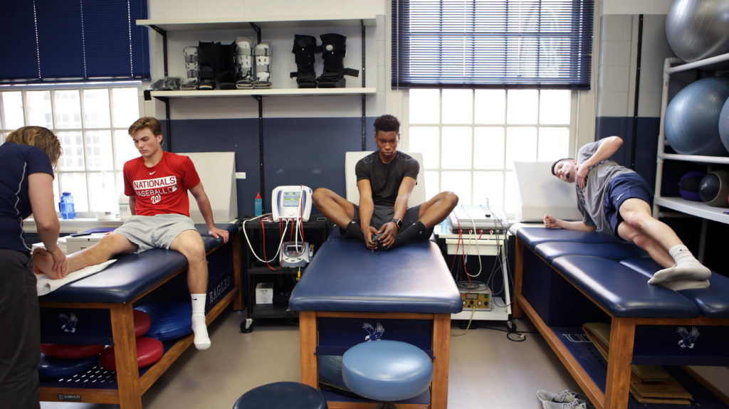 UMW student athletes stretch and meet with athletic trainers on a Wednesday morning.