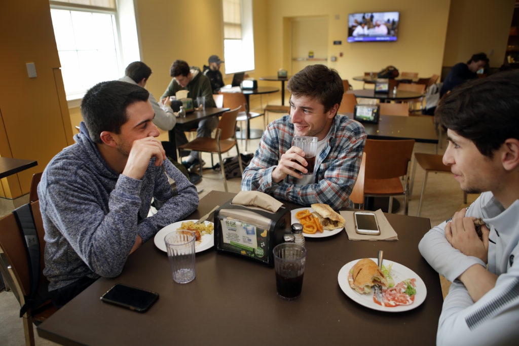 (From left): Sophomores Austin Matz and Ethan Kelly and freshman Sebastian Bonte, members of the men’s golf team, meet for lunch at the University Center.