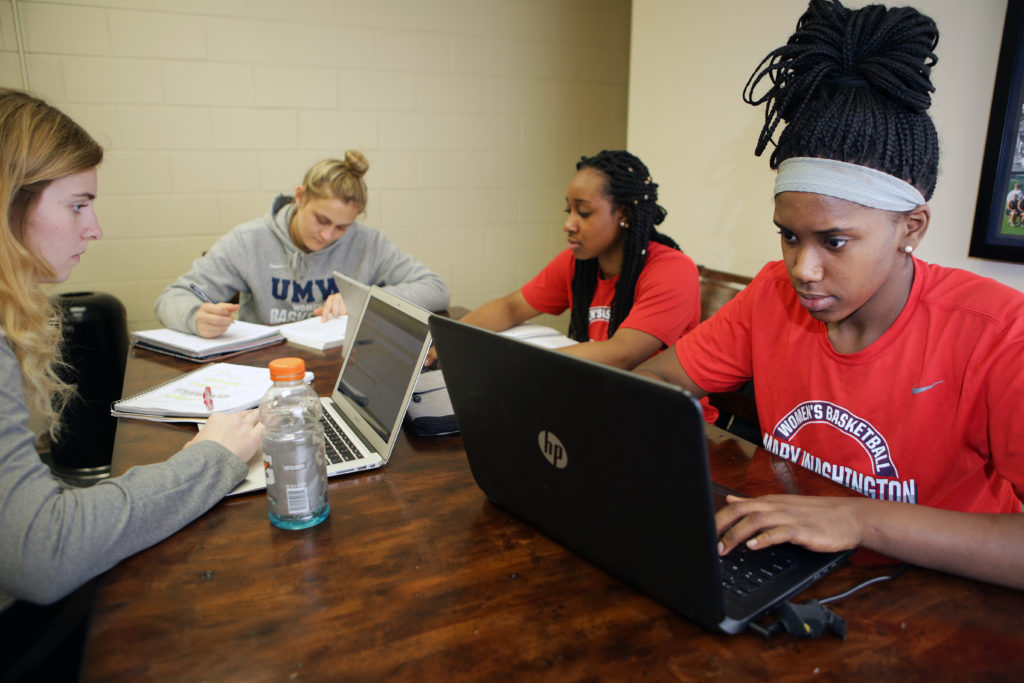 Members of the women’s basketball team sit together during a study hall in the student athlete lounge.