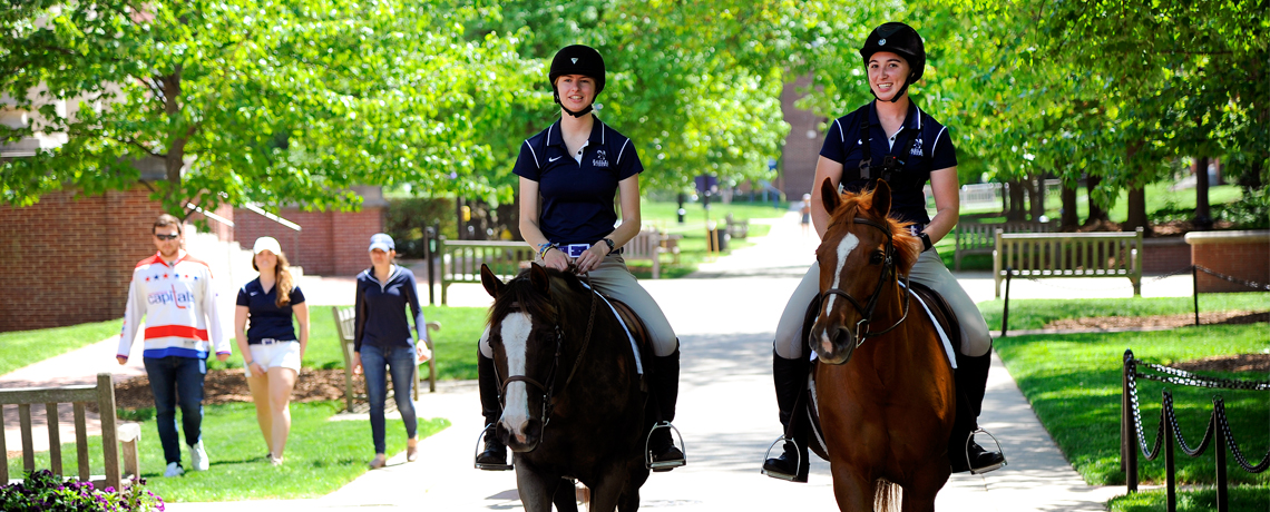Meredith Gregory ’18 and Emily Rothstein ’18, who will graduate Saturday, take a final ride across campus Tuesday, May 8, to commemorate four years on UMW's Equestrian Team.
