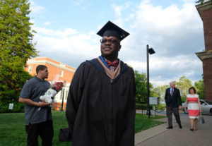 A master's graduate poses for a photo.