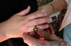 Helen Tracy Totura '43 upholds the tradition of turning the class ring after graduation. The ring is on the hand of her great-granddaughter, Hannah Belski, who graduated today, exactly 75 years after her great-grandmother. Photo by Norm Shafer.