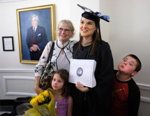 A graduate poses with family.
