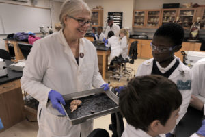 O'Dell works with elementary school students during a summer biology workshop. Photo by Reza Marvashti.