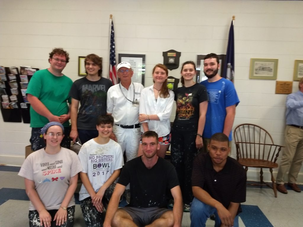 Kline poses with his final group of student painters.