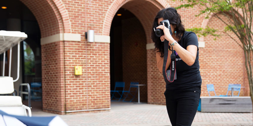 Marissa Juarez, who teaches English at Central New Mexico Community College, uses a camera to complete an assignment during DPL's Digital Storytelling session. Photo by Dave Ellis.