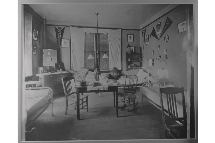 Originally intended for two students, dorm rooms at Willard Hall soon housed three thanks to soaring enrollment. Rooms were equipped with a sink and iron beds, as shown in this 1915 photo. (Simpson Library Special Collections)