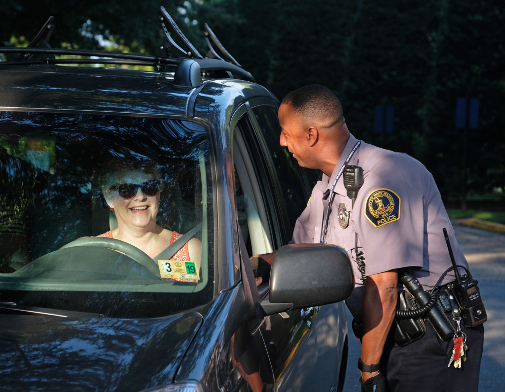 Officer J. Perry welcomes freshmen and their families during move-in day. (Norm Shafer)