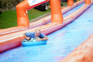 Fredericksburg City Manager Tim Baroody was among the first to ride SlideFXBG, a 1,000-foot waterslide. Photo by Suzanne Rossi.