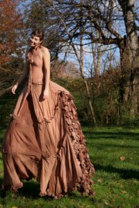 Perry, seen here as an undergrad at Mary Washington, posed at Downtown Greens in stilts and the dress she made from pantyhose. The costume, created for a sculpture class at UMW, won a wearable art competition.