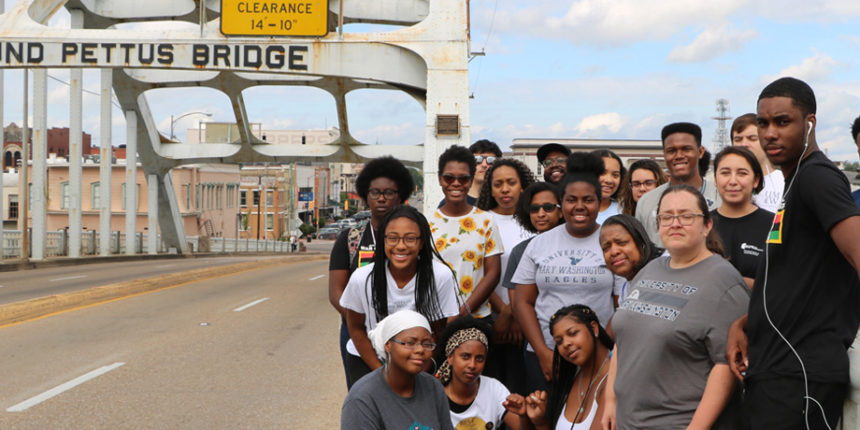 UMW students stand at the end of the Edmund Pettis Bridge during the Fall Break Social Justice trip.