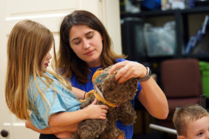 UMW intern Christina Brown shares a moment with Aerietta Shanholtz at Capital Caring's "Coping with Grief at a Holidays" workshop with bereaved families.