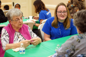 Senior Lindsay Innis talks with families at the recent holiday workshop.