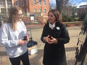 Jamie Opanashuk, UMW's new victim advocate, introduces herself to a student on Campus Walk. Photo by Marty Morrison.