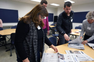 Elva Tolson of Stafford and Clifton Jackson of Arlington choose newspapers for a project during "Blackout Poetry," a creative way to relieve stress. Photo by Suzanne Rossi.