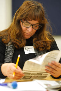 Elva Tolson of Stafford works to "write" a poem from a newspaper article at UMW's Day of Learning.