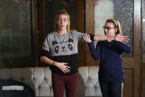 Jessica Elkins helps theatre major Victoria Fortune demonstrate body language concepts during a recent Stage Door Youth Workshop. Photo by Suzanne Rossi.
