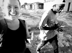 Caroline "Carrie" Maggio, who studied art history at UMW and now a Peace Corps volunteer, walks with a basketball player in Lesotho, South Africa.