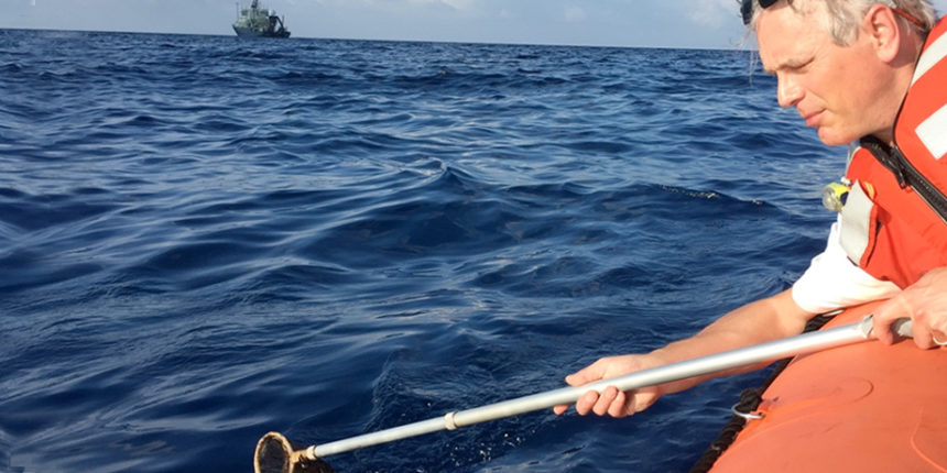 Professor and Chair of the Department of Chemistry Charlie Sharpless captures oil samples in the Gulf of Mexico.