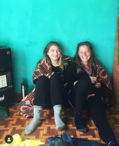 Caroline Maggi (right) sits with a friend in Lesotho, South Africa, where she is a healthcare volunteer for the Peace Corps. After a long day, Maggio said, "watching the sun slip behind the mountains ... puts the biggest smile on my face."