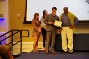 Theodosius Zotos received the Alex Naden Award and the Alumni Association Service Award, presented by Cedric Rucker, associate vice president and dean of Student Life at the Eagle Awards ceremony on Thursday night. Photo by Noah Stroble.