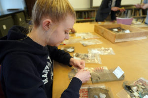 UMW student Tessa Honeycutt works with artifacts from Aquia Creek in the UMW's Combs Hall historic preservation lab. Photo by Suzanne Carr Rossi.
