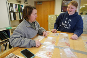 Historic preservation majors Delaney Resweber (left) and Shannon Bremer record information about artifacts uncovered by UMW students and Patawomeck tribe members during a spirng break excavation. Photo by Suzanne Carr Rossi.