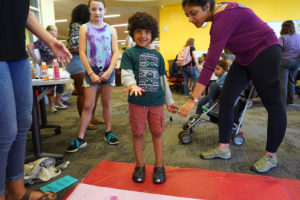 Darshan Nagaraja, 6, prepares to make hand prints during the Multicultural Fair. Photo by Suzanne Carr Rossi.