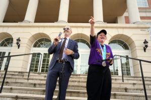 Special Olympian Grace Anne Braxton and President Troy Paino point to Braxton’s parents who attended a reception in her honor at the University Center.