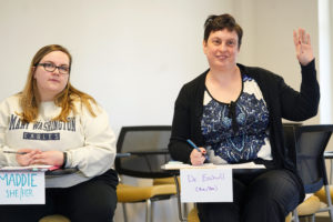 UMW student Maddie Gillespie (left) looks on while Professor of Psychological Sciences Mindy Erchull raises her hand - in her own class - to inject a point. Erchull's Psychology of Women class is heavily discussion-based. Photos by Suzanne Carr Rossi.
