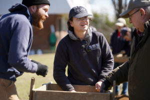 UMW sophomore Ethan Knick talks to Patawomeck Indian chief John Lightner during a spring break archaeological dig at Aquia Creek in Stafford County. Photo by Suzanne Carr Rossi.