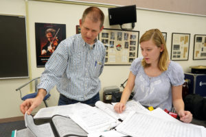 UMW senior Elyse Ridder worked with Department of Music Chair Brooks Kuykendall to reconstruct a pirated score of Gilbert &amp; Sullivan's "H.M.S. Pinafore" made by John Philip Sousa before the American composer catapulted to fame for his patriotic compositions. Photo by Suzanne Rossi.