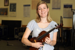 Elyse Ridder '19 has spent her college career working on music manuscript research projects with music department faculty, including UMW Philharmonic Director Kevin Bartram and Professor of Musicology Brooks Kuykendall. Photo by Suzanne Rossi. 