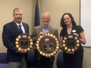 From left to right, Interim Athletic Director Patrick Catullo, UMW President Troy Paino and Vice President for Student Affairs Juliette Landphair accept Mary Washington's Capital Athletic Conference awards this morning. Eagles teams swept the top three spots for the 2018-19 season. Photo by Clint Often.