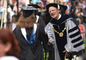 President Troy Paino congratulates a graduate at UMW's 108 commencemnt ceremony.