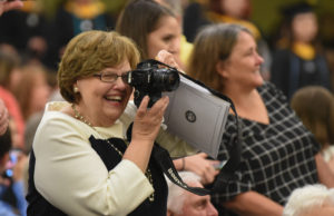An excited mom captures graduation with video. Photo by Clement Britt
