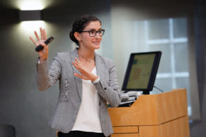 Summer Science Institute participant Kelly Flynn researched the effects of environmental stress on floral development. She presented her findings inside the packed Hurley Convergence Center Digital Auditorium. Photos by Suzanne Carr Rossi.