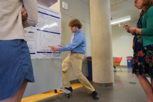 Nicholas Thompson points to a component of his research during the Summer Science Institute Research Symposium. The intensive 10-week session allowed him to delve into research on cortisol levels and stress in zebrafish. Photo by Suzanne Carr Rossi.