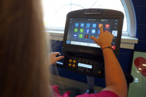 Six of the fitness center's new machines will have touch screens that allow users to check Facebook, watch Netflix and even take a virtual run or ride through Paris or other international locales. Photo by Suzanne Rossi.
