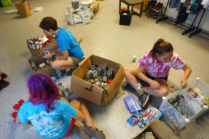 CCE's Faculty Director Leslie Martin works with UMW first-years to stock the Eagle Resource Closet, a food pantry on the fifth floor of Lee Hall. Photo by Suzanne Rossi. 