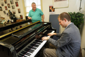 Brooks Kuykendall, shown here with UMW colleague Doug Gately, talks copyrights and pirated productions with 'With Good Reason' radio show host Sarah McConnell. Photo by Suzanne Carr Rossi.