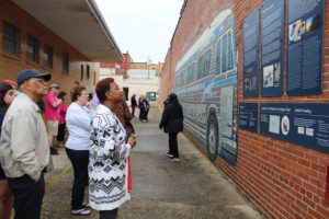 Community members, including Frank White (far left), joined UMW students, faculty and administrators to visit the site where the Ku Klux Klan bombed the Freedom Riders' bus on May 14, 1961 and brutally beat them as they disembarked. Photo by Lynda Allen.