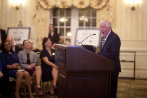 Professor Emeritus William Crawley, founder and director of Great Lives, announces the 17th season of the biographical lecture series to a packed reception at the Jepson Alumni Executive Center. Photo by Karen Pearlman.