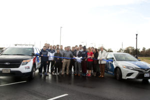 UMW coaches and athletes, and a host of city officials, attended Friday's ribbon cutting for the expanded Battlefield Athletic Complex parking lot. The project highlights a concerted effort on the part of UMW and the City of Fredericksburg to work together for the good of the community. Photo by Karen Pearlman.