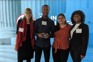 Center for Community Engagement Associate Director Sarah Dewees, A.J. Robinson, Stephanie Turcios and Amber Brown show off UMW's Platinum Seal award at the 2019 ALL IN Campus Democracy Challenge Ceremony at the Newseum in Washington, D.C.
