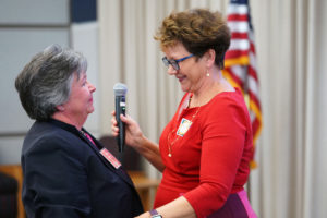 Last year's winner of the Susan Lacey Metzger Distinguished Achievement Award, Central Rappahannock Regional Library Director Martha Hutzel (right), presents this year's honor to UMW College of Business Dean Lynne Richardson. Photos by Suzanne Carr Rossi.