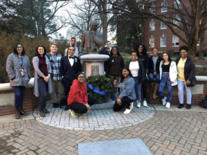 Members of UMW's chapter of the NAACP pose beside the Jamers Farmer bust on Campus Walk. Pictured in front are chapter vice president Bilqiis Sheikh-Issa (left) and president Brianna "Breezy" Reaves.