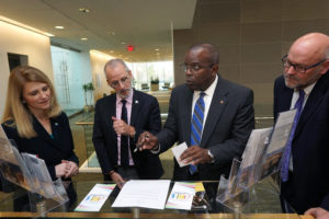 From left to right, Rappahannock Community College President Shannon Kennedy, UMW President Troy Paino, UMW Dahlgren Campus Director Michael Hubbard and RCC Dean of Dual Enrollment and Community Outreach Miles McCrimmon browse through materials at the Dahlgren Campus. The building was the site of a transfer agreement between RCC and UMW. Photos by Suzanne Carr Rossi.