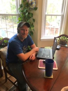 Dave Henderson, an associate professor in the College of Business, teaches classes from his kitchen table.